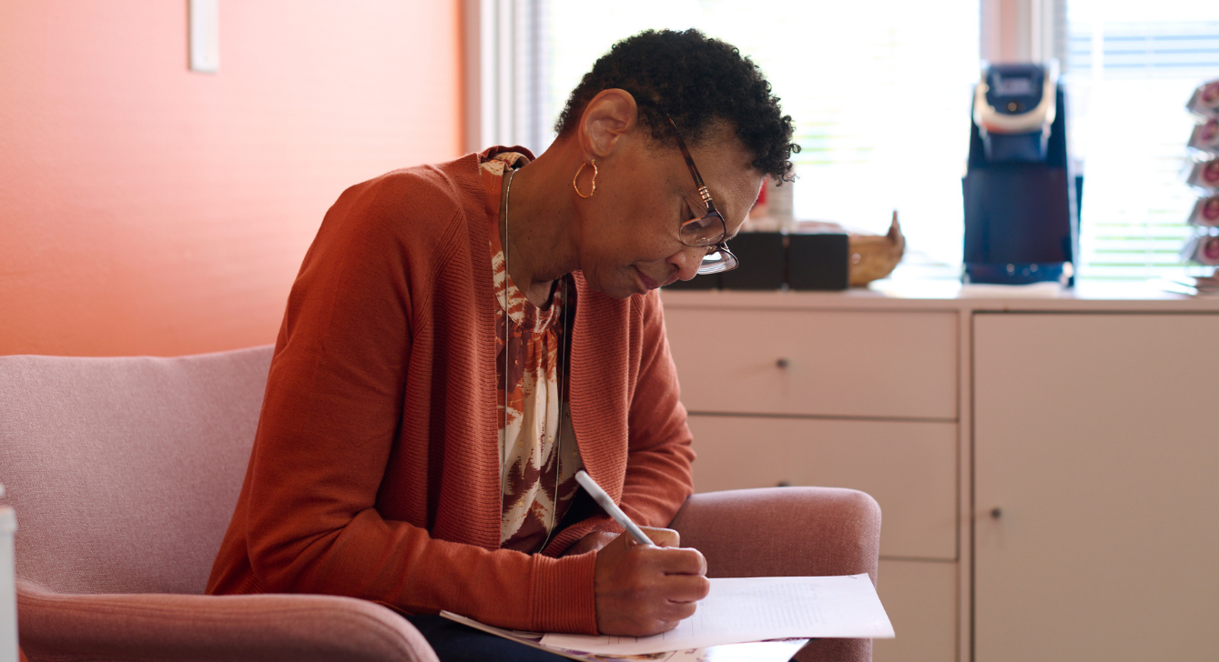 Image of a Gateway to Hope recipient working on financial paperwork.