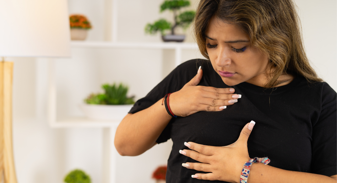 Image of a woman performing a self breast exam.