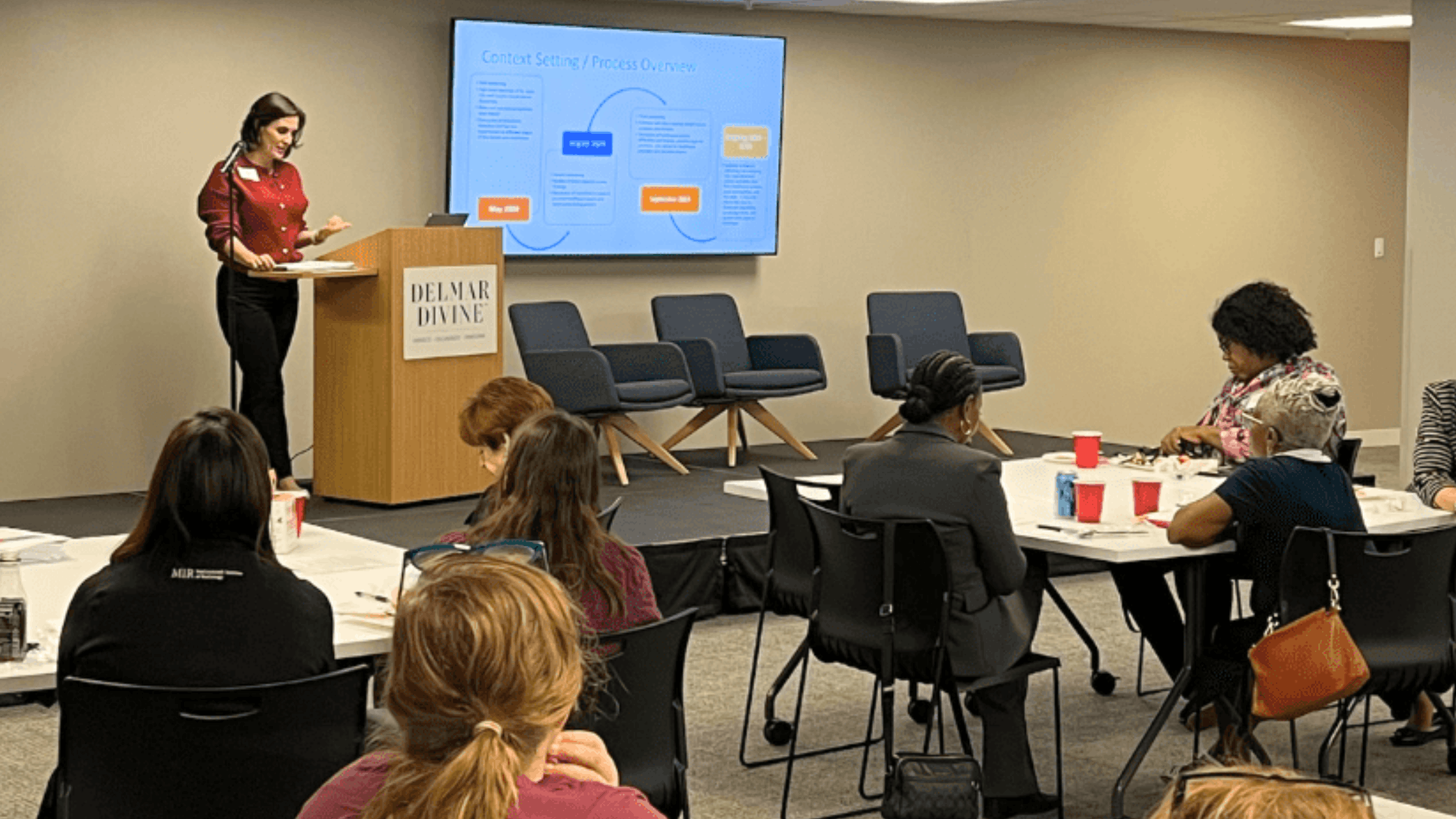 Image of three Black women smiling, standing outside of Gateway to Hope's office. 